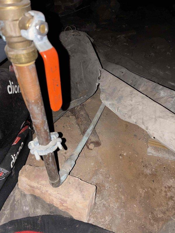 Performed complimentary sewer scope inspection and evaluated plumbing system conditions. Assessed water heater requiring replacement due to age and condition, tested water pressure using calibrated gauge, and documented existing infrastructure including corroded copper piping with brass valve assembly and structural deterioration in utility area foundation corners. Performed complimentary sewer scope inspection and evaluated plumbing system conditions. Assessed water heater requiring replacement due to age and condition, tested water pressure using calibrated gauge, and documented existing infrastructure including corroded copper piping with brass valve assembly and structural deterioration in utility area foundation corners.