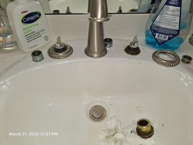 Completed plumbing system inspection and faucet service in residential property. Documented attic crawl space plumbing installation featuring insulated vertical pipe with blue junction box assembly and proper metal strapping to structural framing. Disassembled and serviced bathroom sink faucet, including removal of decorative trim rings, mounting hardware, and spout assembly for maintenance and reassembly. Completed plumbing system inspection and faucet service in residential property. Documented attic crawl space plumbing installation featuring insulated vertical pipe with blue junction box assembly and proper metal strapping to structural framing. Disassembled and serviced bathroom sink faucet, including removal of decorative trim rings, mounting hardware, and spout assembly for maintenance and reassembly.