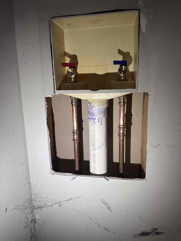 Installed washing machine outlet box with integrated shut-off valves and completed rough-in plumbing connections using copper supply lines and PEX piping. Configured hot and cold water supply valves within recessed wall box and installed drainage assembly with proper access panel for future maintenance. Installed washing machine outlet box with integrated shut-off valves and completed rough-in plumbing connections using copper supply lines and PEX piping. Configured hot and cold water supply valves within recessed wall box and installed drainage assembly with proper access panel for future maintenance.