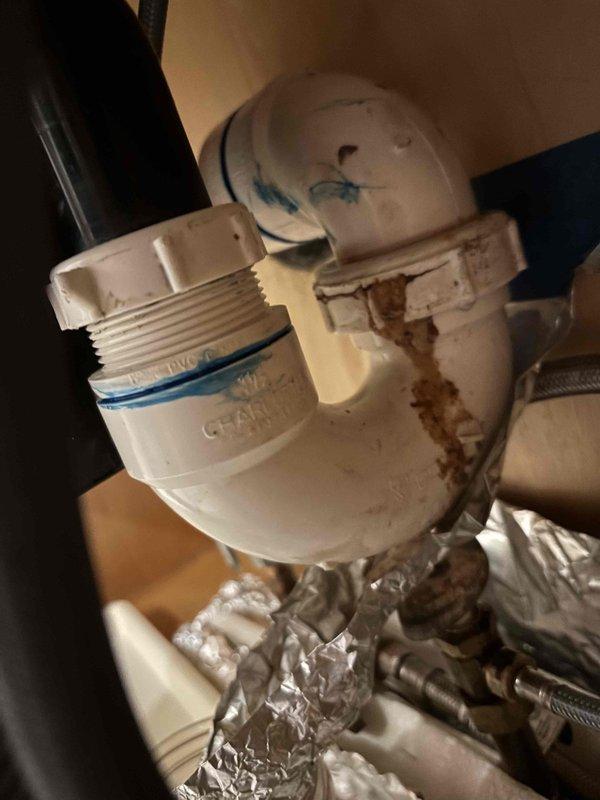 Responded to customer report of leak under kitchen sink. Upon inspection, identified deteriorated drain connections with visible staining and discoloration on PVC piping and fittings. Tested water pressure at main supply line, which registered approximately 80 PSI within normal operating range. Tightened loose drain connections at P-trap assembly and inspected all visible plumbing components for additional leaks or damage. Verified repair by running water through system and confirmed no active leaking present at completion of service. Responded to customer report of leak under kitchen sink. Upon inspection, identified deteriorated drain connections with visible staining and discoloration on PVC piping and fittings. Tested water pressure at main supply line, which registered approximately 80 PSI within normal operating range. Tightened loose drain connections at P-trap assembly and inspected all visible plumbing components for additional leaks or damage. Verified repair by running water through system and confirmed no active leaking present at completion of service.