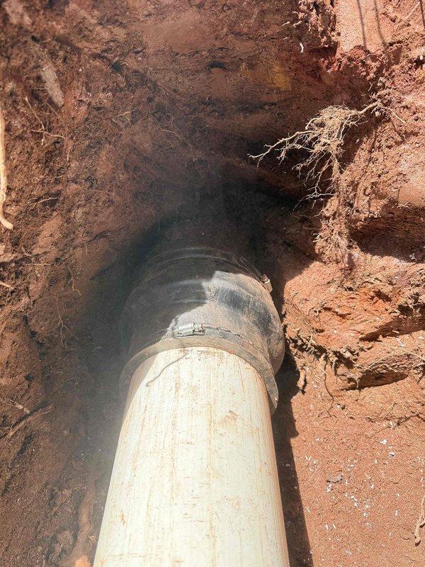 Completed sewer line repair requiring excavation to access and replace damaged underground piping. Excavated trench through clay-rich soil to expose compromised sewer line, removed failed section, and installed new PVC piping with proper coupling connections. Backfilled excavation upon completion of repairs and system verification. Completed sewer line repair requiring excavation to access and replace damaged underground piping. Excavated trench through clay-rich soil to expose compromised sewer line, removed failed section, and installed new PVC piping with proper coupling connections. Backfilled excavation upon completion of repairs and system verification.