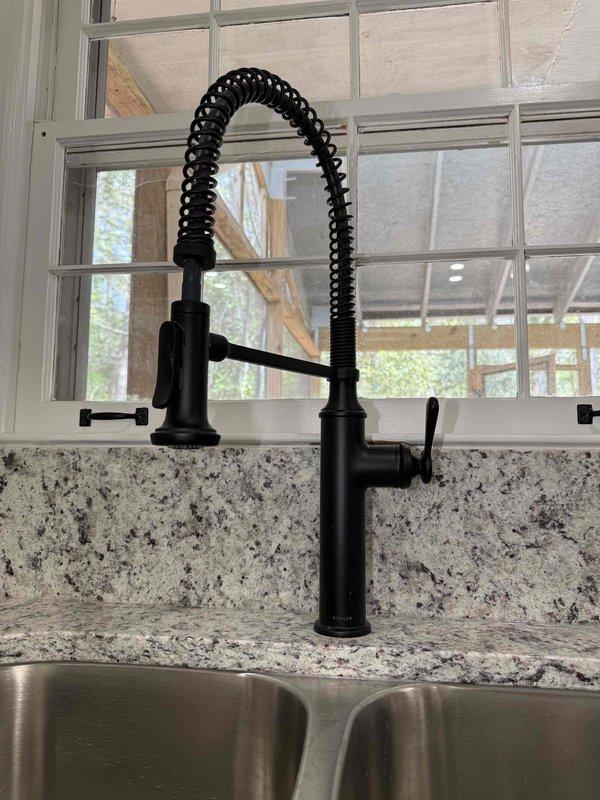 Completed installation and certification of compliance for two Moen faucet fixtures in a residential property. Installed a three-piece widespread bathroom faucet in matte black finish on granite countertop with porcelain sink basin, and a commercial-style pull-down kitchen faucet with coiled spring spout on granite countertop with stainless steel double-bowl sink. Both installations were photographed and documented to verify proper mounting, functionality, and compliance with manufacturer specifications and applicable plumbing codes. Completed installation and certification of compliance for two Moen faucet fixtures in a residential property. Installed a three-piece widespread bathroom faucet in matte black finish on granite countertop with porcelain sink basin, and a commercial-style pull-down kitchen faucet with coiled spring spout on granite countertop with stainless steel double-bowl sink. Both installations were photographed and documented to verify proper mounting, functionality, and compliance with manufacturer specifications and applicable plumbing codes.