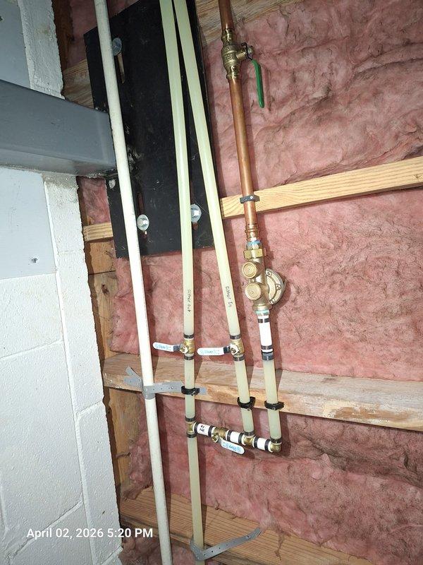 Responded to low water pressure complaint where customer reported all other fixtures losing pressure when water was used at one location. Inspected plumbing system and located water pressure regulator in basement/utility area. Found pressure regulator valve assembly mounted on main copper supply line with brass fittings. Evaluated system configuration and determined regulator required adjustment or potential replacement to restore proper pressure distribution throughout the home. Documented installation with photographs showing regulator position, copper piping runs, and mounting configuration for follow-up service completion when customer becomes available. Responded to low water pressure complaint where customer reported all other fixtures losing pressure when water was used at one location. Inspected plumbing system and located water pressure regulator in basement/utility area. Found pressure regulator valve assembly mounted on main copper supply line with brass fittings. Evaluated system configuration and determined regulator required adjustment or potential replacement to restore proper pressure distribution throughout the home. Documented installation with photographs showing regulator position, copper piping runs, and mounting configuration for follow-up service completion when customer becomes available.