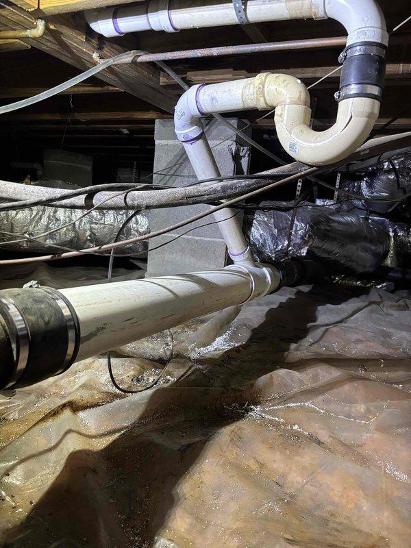 Responded to service call for slow-draining bathtub and suspected water leak in kitchen area. Conducted thorough inspection of accessible plumbing systems, including crawl space examination beneath the structure. Located significant moisture accumulation on vapor barrier in crawl space, with visible water pooling on plastic sheeting beneath kitchen and bathroom areas. Identified condensation and moisture issues affecting insulation materials in accessible underfloor space. Traced PVC drain lines and supply piping throughout crawl space to isolate source of reported dripping sound. Discovered elevated humidity levels and moisture infiltration affecting building envelope in confined areas. Documented conditions of all visible plumbing connections, drain lines, and HVAC condensate systems. Photographed moisture patterns and affected areas for reference and recommended follow-up evaluation to determine if moisture originates from plumbing leak, HVAC condensation, or external water intrusio Responded to service call for slow-draining bathtub and suspected water leak in kitchen area. Conducted thorough inspection of accessible plumbing systems, including crawl space examination beneath the structure. Located significant moisture accumulation on vapor barrier in crawl space, with visible water pooling on plastic sheeting beneath kitchen and bathroom areas. Identified condensation and moisture issues affecting insulation materials in accessible underfloor space. Traced PVC drain lines and supply piping throughout crawl space to isolate source of reported dripping sound. Discovered elevated humidity levels and moisture infiltration affecting building envelope in confined areas. Documented conditions of all visible plumbing connections, drain lines, and HVAC condensate systems. Photographed moisture patterns and affected areas for reference and recommended follow-up evaluation to determine if moisture originates from plumbing leak, HVAC condensation, or external water intrusio