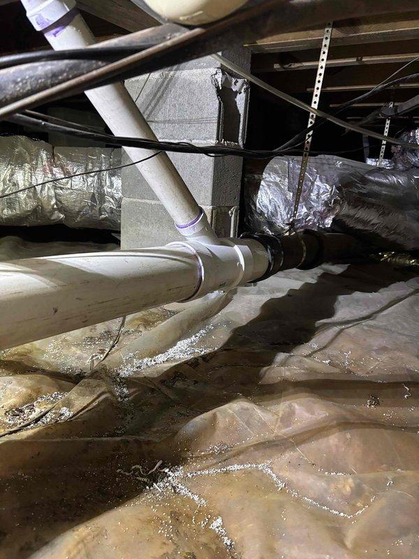 Responded to service call for slow-draining bathtub and suspected water leak in kitchen area. Conducted thorough inspection of accessible plumbing systems, including crawl space examination beneath the structure. Located significant moisture accumulation on vapor barrier in crawl space, with visible water pooling on plastic sheeting beneath kitchen and bathroom areas. Identified condensation and moisture issues affecting insulation materials in accessible underfloor space. Traced PVC drain lines and supply piping throughout crawl space to isolate source of reported dripping sound. Discovered elevated humidity levels and moisture infiltration affecting building envelope in confined areas. Documented conditions of all visible plumbing connections, drain lines, and HVAC condensate systems. Photographed moisture patterns and affected areas for reference and recommended follow-up evaluation to determine if moisture originates from plumbing leak, HVAC condensation, or external water intrusio Responded to service call for slow-draining bathtub and suspected water leak in kitchen area. Conducted thorough inspection of accessible plumbing systems, including crawl space examination beneath the structure. Located significant moisture accumulation on vapor barrier in crawl space, with visible water pooling on plastic sheeting beneath kitchen and bathroom areas. Identified condensation and moisture issues affecting insulation materials in accessible underfloor space. Traced PVC drain lines and supply piping throughout crawl space to isolate source of reported dripping sound. Discovered elevated humidity levels and moisture infiltration affecting building envelope in confined areas. Documented conditions of all visible plumbing connections, drain lines, and HVAC condensate systems. Photographed moisture patterns and affected areas for reference and recommended follow-up evaluation to determine if moisture originates from plumbing leak, HVAC condensation, or external water intrusio