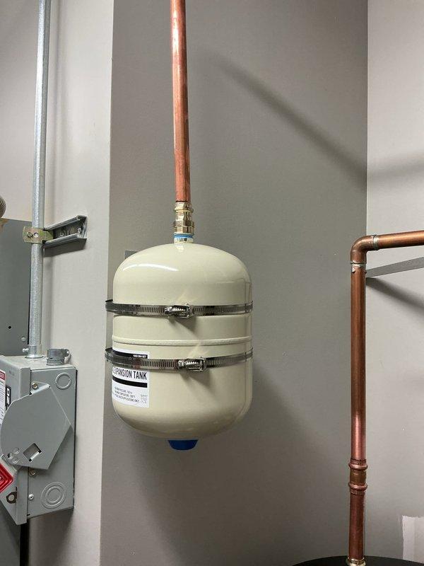 Completed installation of Rheem residential water heater system with all required plumbing connections and safety components. Installed expansion tank with proper mounting brackets and brass fittings, connected copper supply and distribution lines with appropriate shutoff valves, and integrated PVC venting system. All connections were properly secured, tested for leaks, and verified operational per manufacturer specifications. Completed installation of Rheem residential water heater system with all required plumbing connections and safety components. Installed expansion tank with proper mounting brackets and brass fittings, connected copper supply and distribution lines with appropriate shutoff valves, and integrated PVC venting system. All connections were properly secured, tested for leaks, and verified operational per manufacturer specifications.
