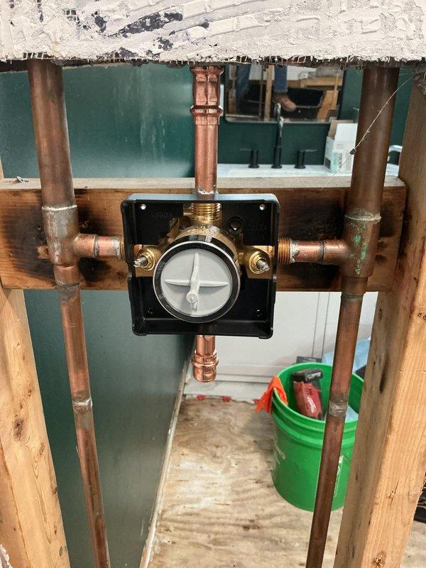 Installed customer-supplied shower valve in bathroom plumbing system, working through floor access point to connect copper supply lines to new valve assembly with pressure balancing mechanism. Secured valve to mounting plate between floor joists and verified all connections for proper operation. Installed customer-supplied shower valve in bathroom plumbing system, working through floor access point to connect copper supply lines to new valve assembly with pressure balancing mechanism. Secured valve to mounting plate between floor joists and verified all connections for proper operation.