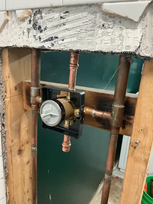 Installed customer-supplied shower valve in bathroom plumbing system, working through floor access point to connect copper supply lines to new valve assembly with pressure balancing mechanism. Secured valve to mounting plate between floor joists and verified all connections for proper operation. Installed customer-supplied shower valve in bathroom plumbing system, working through floor access point to connect copper supply lines to new valve assembly with pressure balancing mechanism. Secured valve to mounting plate between floor joists and verified all connections for proper operation.