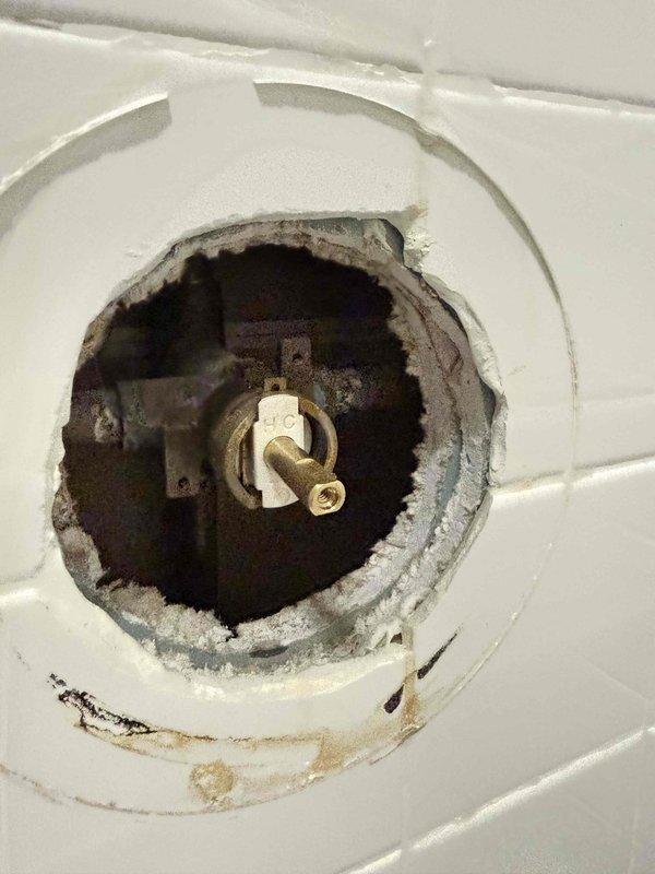 Responded to customer report of water dripping from shower faucet. Upon inspection, found heavily corroded valve cartridge with significant mineral buildup and rust accumulation around the valve assembly. Removed deteriorated cartridge, cleaned valve body and trim plate, and installed new replacement cartridge. Tested operation to verify proper function and confirmed leak was eliminated. Responded to customer report of water dripping from shower faucet. Upon inspection, found heavily corroded valve cartridge with significant mineral buildup and rust accumulation around the valve assembly. Removed deteriorated cartridge, cleaned valve body and trim plate, and installed new replacement cartridge. Tested operation to verify proper function and confirmed leak was eliminated.