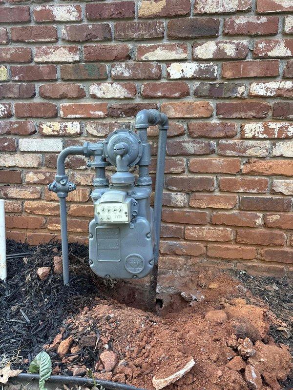 Responded to gas leak call at exterior meter location. Upon inspection, identified severely corroded metal gas line in crawl space area beneath meter assembly. The deteriorated pipe showed extensive black rust and structural compromise where it penetrated the foundation. Documented conditions with photographs showing both the exterior meter installation on brick wall and the underground corroded pipe section. Due to safety concerns and extent of corrosion, shut off gas supply at meter and tagged system as unsafe for operation until proper repairs could be completed by qualified gas line contractor. Responded to gas leak call at exterior meter location. Upon inspection, identified severely corroded metal gas line in crawl space area beneath meter assembly. The deteriorated pipe showed extensive black rust and structural compromise where it penetrated the foundation. Documented conditions with photographs showing both the exterior meter installation on brick wall and the underground corroded pipe section. Due to safety concerns and extent of corrosion, shut off gas supply at meter and tagged system as unsafe for operation until proper repairs could be completed by qualified gas line contractor.