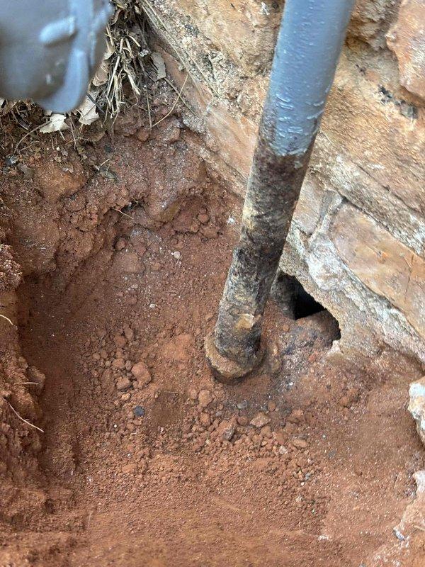 Responded to gas leak call at exterior meter location. Upon inspection, identified severely corroded metal gas line in crawl space area beneath meter assembly. The deteriorated pipe showed extensive black rust and structural compromise where it penetrated the foundation. Documented conditions with photographs showing both the exterior meter installation on brick wall and the underground corroded pipe section. Due to safety concerns and extent of corrosion, shut off gas supply at meter and tagged system as unsafe for operation until proper repairs could be completed by qualified gas line contractor. Responded to gas leak call at exterior meter location. Upon inspection, identified severely corroded metal gas line in crawl space area beneath meter assembly. The deteriorated pipe showed extensive black rust and structural compromise where it penetrated the foundation. Documented conditions with photographs showing both the exterior meter installation on brick wall and the underground corroded pipe section. Due to safety concerns and extent of corrosion, shut off gas supply at meter and tagged system as unsafe for operation until proper repairs could be completed by qualified gas line contractor.
