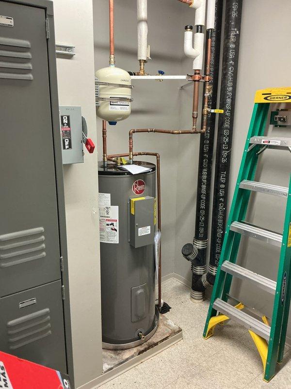 Completed installation of water heater isolation valve with blue handle on main supply line. Valve installed on copper piping to provide shut-off capability for the Rheem water heater system. All connections properly secured with brass fittings, and flexible connector attached to valve outlet. System tested for leaks and proper operation confirmed. Completed installation of water heater isolation valve with blue handle on main supply line. Valve installed on copper piping to provide shut-off capability for the Rheem water heater system. All connections properly secured with brass fittings, and flexible connector attached to valve outlet. System tested for leaks and proper operation confirmed.