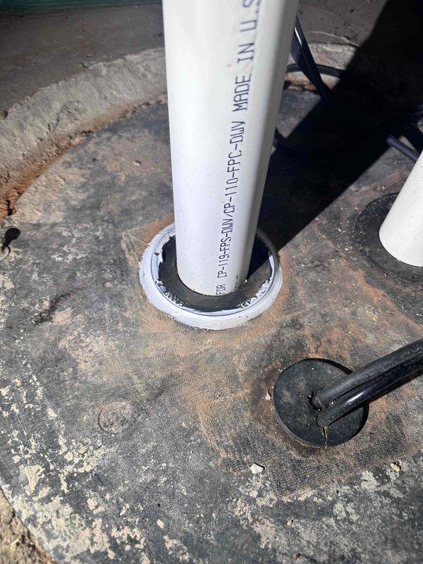 Responded to customer complaint of sewer odor in basement. Conducted thorough inspection of plumbing system and ventilation components. Investigation traced odor source to rooftop plumbing vents. Documented two separate vent pipe penetrations through roof surface, including weathered PVC Schedule 40 DWV piping passing through metal access cover and roof flashing assembly. Observed significant deterioration of roof membrane and sealing components around vent penetrations, indicating potential pathways for sewer gas infiltration back into building envelope. Photographed conditions showing compromised rubber grommets and deteriorated flashing boots that could allow gas bypass. Recommended resealing vent penetrations and evaluating vent stack termination heights to ensure proper atmospheric venting and prevent negative pressure conditions that draw sewer gases into occupied spaces. Responded to customer complaint of sewer odor in basement. Conducted thorough inspection of plumbing system and ventilation components. Investigation traced odor source to rooftop plumbing vents. Documented two separate vent pipe penetrations through roof surface, including weathered PVC Schedule 40 DWV piping passing through metal access cover and roof flashing assembly. Observed significant deterioration of roof membrane and sealing components around vent penetrations, indicating potential pathways for sewer gas infiltration back into building envelope. Photographed conditions showing compromised rubber grommets and deteriorated flashing boots that could allow gas bypass. Recommended resealing vent penetrations and evaluating vent stack termination heights to ensure proper atmospheric venting and prevent negative pressure conditions that draw sewer gases into occupied spaces.