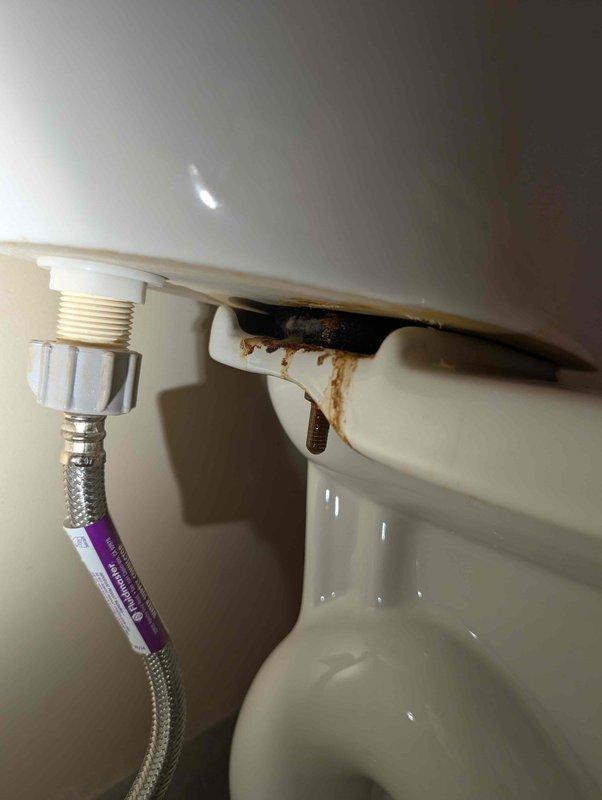 Responded to complaint of sewer odor in bathroom. Upon inspection, identified severe mineral buildup and debris in faucet aerator, which was removed and documented. Also discovered significant rust corrosion and deterioration on toilet tank-to-bowl mounting hardware with visible water staining, indicating a potential source of sewer gas infiltration through compromised seal integrity. Responded to complaint of sewer odor in bathroom. Upon inspection, identified severe mineral buildup and debris in faucet aerator, which was removed and documented. Also discovered significant rust corrosion and deterioration on toilet tank-to-bowl mounting hardware with visible water staining, indicating a potential source of sewer gas infiltration through compromised seal integrity.
