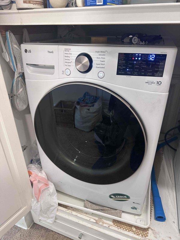 Responded to service call regarding unusual noise emanating from wall during washing machine operation. Upon arrival, inspected LG ThinQ front-loading washing machine and surrounding laundry area. Documented appliance condition and installation setup, noting machine positioned on white platform base with control panel displaying normal operational indicators.
Investigated potential noise sources by examining water supply connections and pressure regulation system. Inspected pressure gauge assembly showing readings within normal operating range (0-200 scale), connected red ball valve, and associated copper and brass threaded piping. Evaluated flexible hose connections and mechanical components for signs of water hammer, loose fittings, or vibration transmission to wall structure. Photographed plumbing infrastructure including gauge assembly, valve connections, and pipe routing to document current installation configuration for further assessment if needed. Responded to service call regarding unusual noise emanating from wall during washing machine operation. Upon arrival, inspected LG ThinQ front-loading washing machine and surrounding laundry area. Documented appliance condition and installation setup, noting machine positioned on white platform base with control panel displaying normal operational indicators.
Investigated potential noise sources by examining water supply connections and pressure regulation system. Inspected pressure gauge assembly showing readings within normal operating range (0-200 scale), connected red ball valve, and associated copper and brass threaded piping. Evaluated flexible hose connections and mechanical components for signs of water hammer, loose fittings, or vibration transmission to wall structure. Photographed plumbing infrastructure including gauge assembly, valve connections, and pipe routing to document current installation configuration for further assessment if needed.