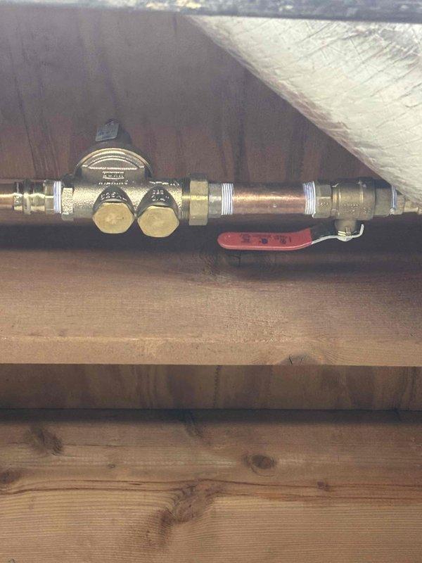Responded to report of water leak in basement ceiling. Upon investigation, located source at copper pipe assembly with multiple brass fittings and pressure gauge installed between floor joists above affected area. Inspected piping system, identified leak point at compression fitting, and completed necessary repairs to resolve water intrusion issue. Responded to report of water leak in basement ceiling. Upon investigation, located source at copper pipe assembly with multiple brass fittings and pressure gauge installed between floor joists above affected area. Inspected piping system, identified leak point at compression fitting, and completed necessary repairs to resolve water intrusion issue.