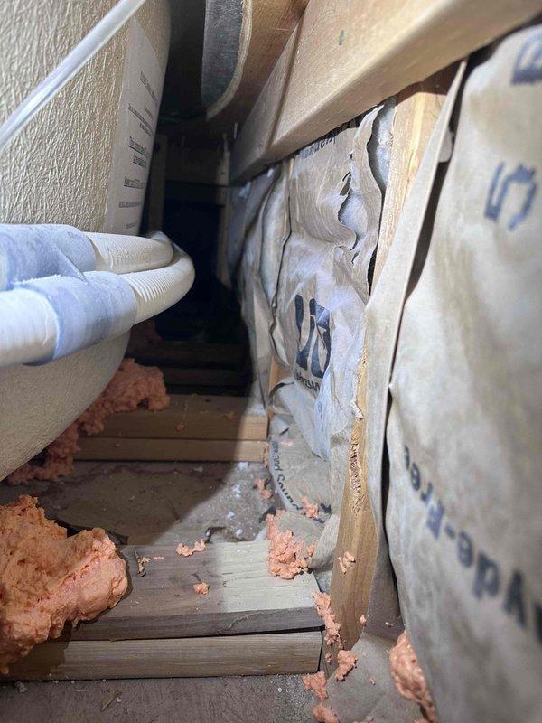 Responded to water leak in garage ceiling originating from master bathroom above. Investigated bath/shower area and accessed wall cavity to identify source of leak. Removed and displaced fiberglass insulation to expose plumbing connections and drainage system, including corrugated flexible pipe. Documented water damage and construction areas requiring repair. Recommended installation of GoveeLife smart water leak detection system with WiFi connectivity and multiple sensors for basement, kitchen, and bathroom areas to provide early warning of future leaks and prevent additional damage. Responded to water leak in garage ceiling originating from master bathroom above. Investigated bath/shower area and accessed wall cavity to identify source of leak. Removed and displaced fiberglass insulation to expose plumbing connections and drainage system, including corrugated flexible pipe. Documented water damage and construction areas requiring repair. Recommended installation of GoveeLife smart water leak detection system with WiFi connectivity and multiple sensors for basement, kitchen, and bathroom areas to provide early warning of future leaks and prevent additional damage.