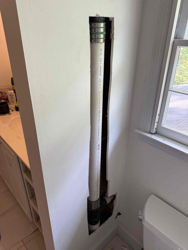 Responded to service call for leaking vent pipe in bathroom. Upon inspection, located the source of the leak within the wall cavity behind the toilet. Created access opening in drywall to expose the plumbing system and identified compromised pipe connection. Repaired the leaking vent pipe by securing connections with proper clamps and replacing damaged pipe segments. Verified repair integrity and confirmed no active leaks present upon completion. Responded to service call for leaking vent pipe in bathroom. Upon inspection, located the source of the leak within the wall cavity behind the toilet. Created access opening in drywall to expose the plumbing system and identified compromised pipe connection. Repaired the leaking vent pipe by securing connections with proper clamps and replacing damaged pipe segments. Verified repair integrity and confirmed no active leaks present upon completion.