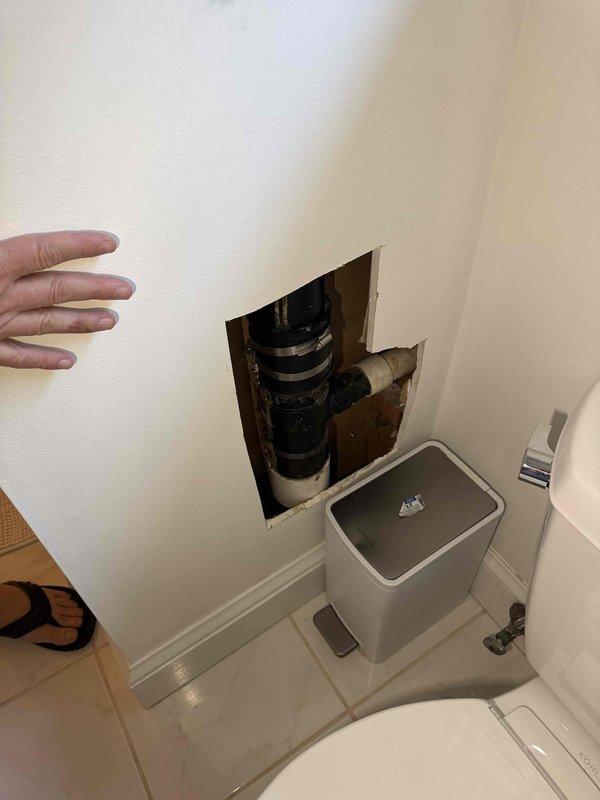 Responded to service call for leaking vent pipe in bathroom. Upon inspection, located the source of the leak within the wall cavity behind the toilet. Created access opening in drywall to expose the plumbing system and identified compromised pipe connection. Repaired the leaking vent pipe by securing connections with proper clamps and replacing damaged pipe segments. Verified repair integrity and confirmed no active leaks present upon completion. Responded to service call for leaking vent pipe in bathroom. Upon inspection, located the source of the leak within the wall cavity behind the toilet. Created access opening in drywall to expose the plumbing system and identified compromised pipe connection. Repaired the leaking vent pipe by securing connections with proper clamps and replacing damaged pipe segments. Verified repair integrity and confirmed no active leaks present upon completion.