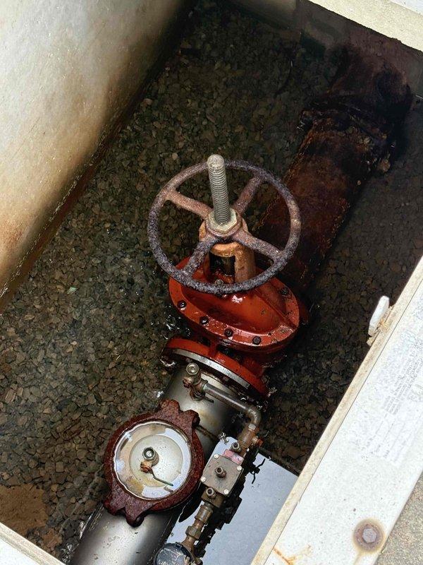 Responded to report of water pooling in front of building. Upon investigation, located underground utility vault containing main water control valve assembly. Inspection revealed aged valve system with significant corrosion on handwheel and associated piping components, along with deteriorated seals that were allowing water to escape into the surrounding area. Documented existing conditions of valve assembly, meter connections, and vault infrastructure for repair recommendations. Responded to report of water pooling in front of building. Upon investigation, located underground utility vault containing main water control valve assembly. Inspection revealed aged valve system with significant corrosion on handwheel and associated piping components, along with deteriorated seals that were allowing water to escape into the surrounding area. Documented existing conditions of valve assembly, meter connections, and vault infrastructure for repair recommendations.