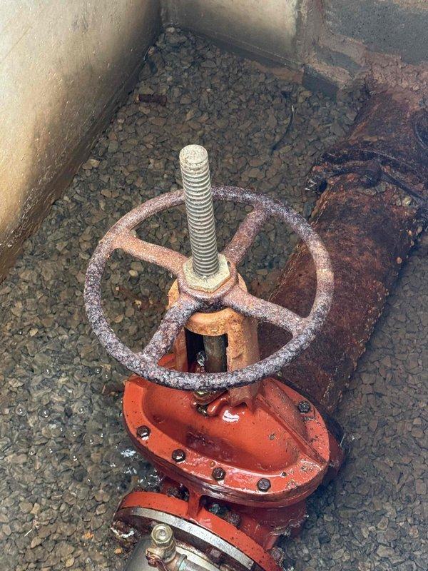 Responded to report of water pooling in front of building. Upon investigation, located underground utility vault containing main water control valve assembly. Inspection revealed aged valve system with significant corrosion on handwheel and associated piping components, along with deteriorated seals that were allowing water to escape into the surrounding area. Documented existing conditions of valve assembly, meter connections, and vault infrastructure for repair recommendations. Responded to report of water pooling in front of building. Upon investigation, located underground utility vault containing main water control valve assembly. Inspection revealed aged valve system with significant corrosion on handwheel and associated piping components, along with deteriorated seals that were allowing water to escape into the surrounding area. Documented existing conditions of valve assembly, meter connections, and vault infrastructure for repair recommendations.