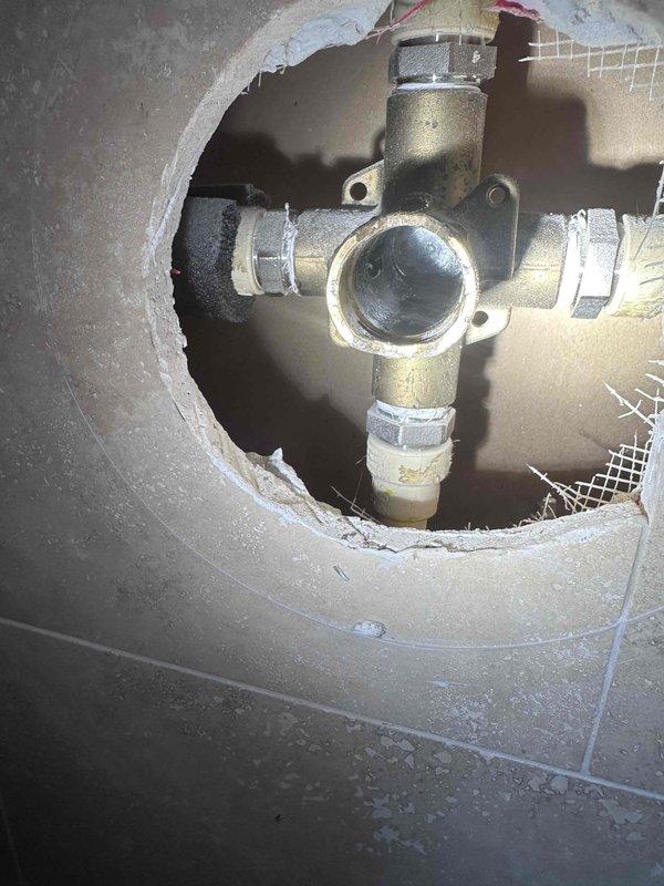 Responded to service call for leaking shower with mobility and stability issues. Upon inspection, accessed plumbing fixture behind wall to diagnose source of leak. Identified compromised shower valve assembly and loose supply line connections contributing to water leakage. Removed defective braided supply hose and cross-fitting valve assembly. Replaced faulty components with new fixtures, ensuring proper threading and secure connections at all attachment points. Verified water-tight seal and tested shower operation to confirm leak was resolved and fixture stability restored. Responded to service call for leaking shower with mobility and stability issues. Upon inspection, accessed plumbing fixture behind wall to diagnose source of leak. Identified compromised shower valve assembly and loose supply line connections contributing to water leakage. Removed defective braided supply hose and cross-fitting valve assembly. Replaced faulty components with new fixtures, ensuring proper threading and secure connections at all attachment points. Verified water-tight seal and tested shower operation to confirm leak was resolved and fixture stability restored.