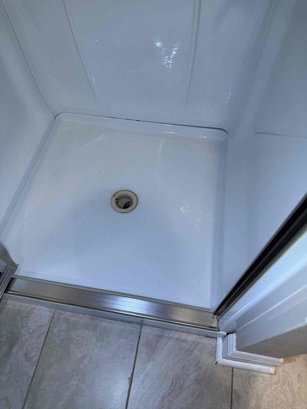 Responded to a clogged basement toilet that was backing up into the adjacent shower drain. Successfully cleared the blockage and restored proper drainage to both fixtures. The bathroom is equipped with fixtures that may require a sewage ejection pump system for optimal long-term performance, as previously assessed.