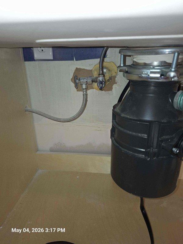 Installed customer-supplied garbage disposal and connected new kitchen faucet under sink, ensuring proper mounting and secure drain connections. Replaced Pfister shower cartridge to restore proper temperature control and water flow to the shower valve.