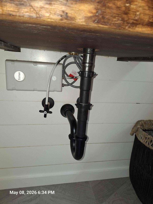 Completed installation of special order vessel sink and wall-mounted faucet assembly with black P-trap drainage system. Installed gray control box with flexible supply line connection, routed electrical wiring for automated fixture operation, and verified all plumbing connections for proper drainage and leak-free performance beneath countertop. Completed installation of special order vessel sink and wall-mounted faucet assembly with black P-trap drainage system. Installed gray control box with flexible supply line connection, routed electrical wiring for automated fixture operation, and verified all plumbing connections for proper drainage and leak-free performance beneath countertop.