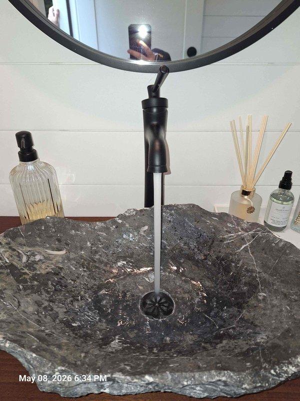 Completed installation of special order vessel sink and wall-mounted faucet assembly with black P-trap drainage system. Installed gray control box with flexible supply line connection, routed electrical wiring for automated fixture operation, and verified all plumbing connections for proper drainage and leak-free performance beneath countertop. Completed installation of special order vessel sink and wall-mounted faucet assembly with black P-trap drainage system. Installed gray control box with flexible supply line connection, routed electrical wiring for automated fixture operation, and verified all plumbing connections for proper drainage and leak-free performance beneath countertop.