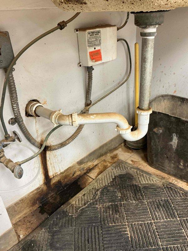 Responded to service call for multiple water leaks at residential property. Inspected and documented hydration room where broken connection was identified through drainage system filter, causing active water intrusion. Evaluated outdoor spigot with confirmed leak and assessed water meter box found completely filled with water. Photographic documentation captured water heater installation area showing significant moisture damage to baseboards and flooring, along with corrosion on tank base and surrounding plumbing connections. Additional images documented drainage system valve component with visible wear and discoloration on PVC connections. Provided comprehensive estimate for repair of broken drainage connection, outdoor spigot replacement, and water meter box remediation to resolve all identified leak sources. Responded to service call for multiple water leaks at residential property. Inspected and documented hydration room where broken connection was identified through drainage system filter, causing active water intrusion. Evaluated outdoor spigot with confirmed leak and assessed water meter box found completely filled with water. Photographic documentation captured water heater installation area showing significant moisture damage to baseboards and flooring, along with corrosion on tank base and surrounding plumbing connections. Additional images documented drainage system valve component with visible wear and discoloration on PVC connections. Provided comprehensive estimate for repair of broken drainage connection, outdoor spigot replacement, and water meter box remediation to resolve all identified leak sources.