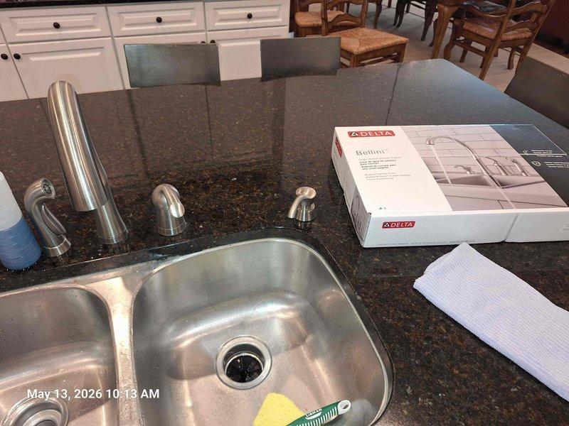 Installed customer-supplied Delta Bellini kitchen faucet in double-basin stainless steel sink with dark granite countertop. Completed installation of faucet spout and handle components, with all fixtures properly mounted and operational. Installed customer-supplied Delta Bellini kitchen faucet in double-basin stainless steel sink with dark granite countertop. Completed installation of faucet spout and handle components, with all fixtures properly mounted and operational.