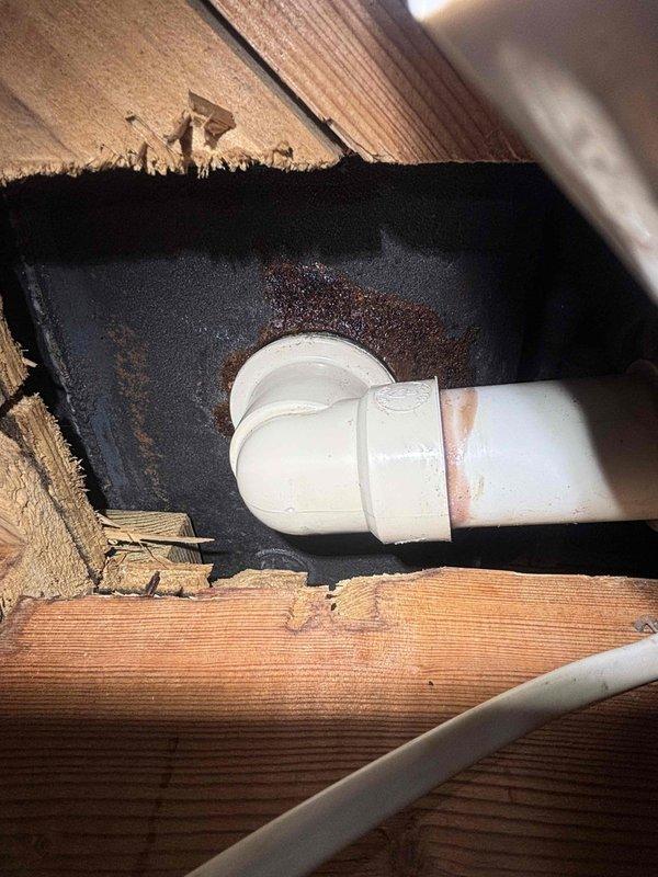 Responded to reported ceiling leak and traced source to bathroom plumbing above affected area. Upon investigation, identified leaking jet tub drain assembly allowing water to seep through floor joists into ceiling below. Documented existing water staining on subfloor and structural members surrounding white PVC drain piping. Tightened drain connections and inspected all jet tub plumbing fixtures for proper sealing to prevent further water intrusion and damage to ceiling below. Responded to reported ceiling leak and traced source to bathroom plumbing above affected area. Upon investigation, identified leaking jet tub drain assembly allowing water to seep through floor joists into ceiling below. Documented existing water staining on subfloor and structural members surrounding white PVC drain piping. Tightened drain connections and inspected all jet tub plumbing fixtures for proper sealing to prevent further water intrusion and damage to ceiling below.
