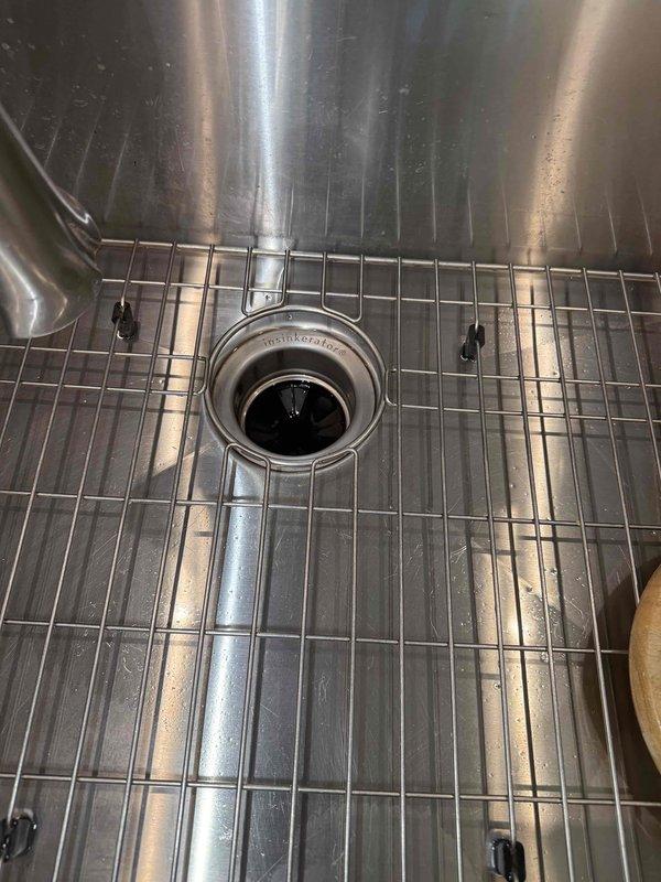 Responded to service call for leaking garbage disposal unit. Upon inspection, identified leak source at disposal mounting assembly and drain connections. Removed existing disposal unit, cleaned mounting flange and sink drain opening, reinstalled unit with new mounting hardware and plumber's putty to ensure proper seal, reconnected dishwasher drain line and P-trap assembly, tested all connections for leaks, and verified proper operation of disposal unit. Responded to service call for leaking garbage disposal unit. Upon inspection, identified leak source at disposal mounting assembly and drain connections. Removed existing disposal unit, cleaned mounting flange and sink drain opening, reinstalled unit with new mounting hardware and plumber's putty to ensure proper seal, reconnected dishwasher drain line and P-trap assembly, tested all connections for leaks, and verified proper operation of disposal unit.