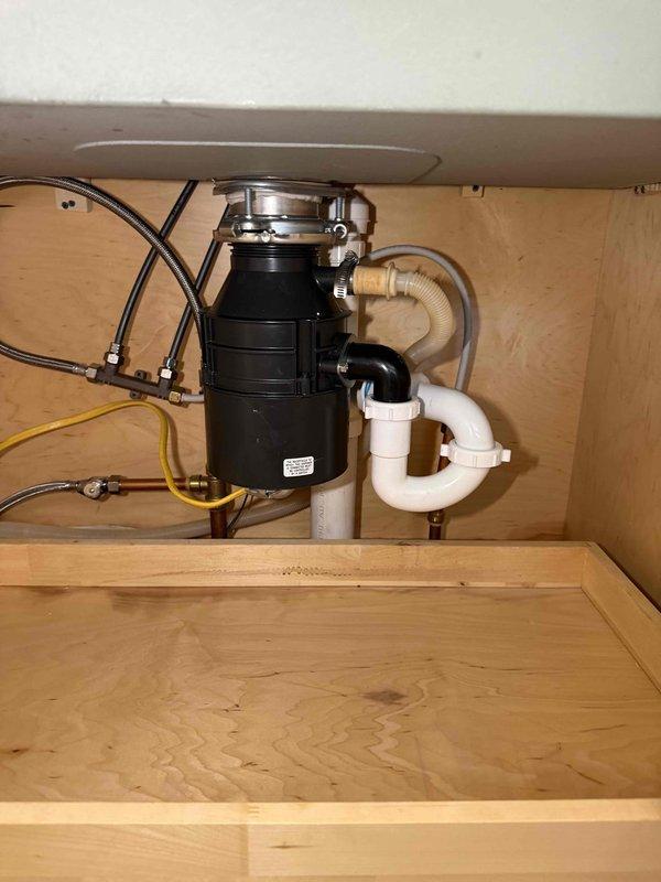 Responded to service call for leaking garbage disposal unit. Upon inspection, identified leak source at disposal mounting assembly and drain connections. Removed existing disposal unit, cleaned mounting flange and sink drain opening, reinstalled unit with new mounting hardware and plumber's putty to ensure proper seal, reconnected dishwasher drain line and P-trap assembly, tested all connections for leaks, and verified proper operation of disposal unit. Responded to service call for leaking garbage disposal unit. Upon inspection, identified leak source at disposal mounting assembly and drain connections. Removed existing disposal unit, cleaned mounting flange and sink drain opening, reinstalled unit with new mounting hardware and plumber's putty to ensure proper seal, reconnected dishwasher drain line and P-trap assembly, tested all connections for leaks, and verified proper operation of disposal unit.