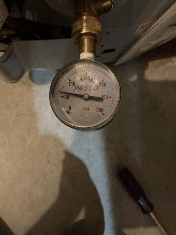 Responded to plumbing repair call for reported pressure issue. Upon inspection, evaluated residential water pressure using calibrated PASCO pressure gauge mounted on brass fittings in utility area. Additionally inspected toilet tank internal components, documenting deteriorated flush valve assembly with worn red rubber flapper, corroded fill valve mechanism, and significant mineral deposits and rust staining throughout tank interior indicating water quality concerns that may contribute to system pressure irregularities. Responded to plumbing repair call for reported pressure issue. Upon inspection, evaluated residential water pressure using calibrated PASCO pressure gauge mounted on brass fittings in utility area. Additionally inspected toilet tank internal components, documenting deteriorated flush valve assembly with worn red rubber flapper, corroded fill valve mechanism, and significant mineral deposits and rust staining throughout tank interior indicating water quality concerns that may contribute to system pressure irregularities.