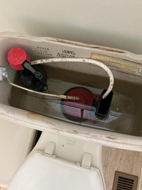 Responded to plumbing repair call for reported pressure issue. Upon inspection, evaluated residential water pressure using calibrated PASCO pressure gauge mounted on brass fittings in utility area. Additionally inspected toilet tank internal components, documenting deteriorated flush valve assembly with worn red rubber flapper, corroded fill valve mechanism, and significant mineral deposits and rust staining throughout tank interior indicating water quality concerns that may contribute to system pressure irregularities. Responded to plumbing repair call for reported pressure issue. Upon inspection, evaluated residential water pressure using calibrated PASCO pressure gauge mounted on brass fittings in utility area. Additionally inspected toilet tank internal components, documenting deteriorated flush valve assembly with worn red rubber flapper, corroded fill valve mechanism, and significant mineral deposits and rust staining throughout tank interior indicating water quality concerns that may contribute to system pressure irregularities.