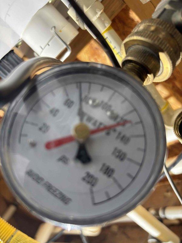 Responded to service call for tankless water heater with reported leak from connected piping and non-functional recirculation pump. Upon arrival, inspected mechanical room installation including expansion tank, pressure regulation system, and PVC/copper piping network. Located leak source at pipe connection point near tankless unit. Diagnosed recirculation pump failure preventing hot water circulation throughout system. Verified system pressure readings via installed gauge to ensure proper operating parameters. Assessed complete plumbing configuration including multiple pipe runs, fittings, and control components within exposed wall cavity installation. Documented existing conditions through photography showing expansion tank mounting, pressure monitoring equipment, and complex piping arrangement with various connections and valves. Responded to service call for tankless water heater with reported leak from connected piping and non-functional recirculation pump. Upon arrival, inspected mechanical room installation including expansion tank, pressure regulation system, and PVC/copper piping network. Located leak source at pipe connection point near tankless unit. Diagnosed recirculation pump failure preventing hot water circulation throughout system. Verified system pressure readings via installed gauge to ensure proper operating parameters. Assessed complete plumbing configuration including multiple pipe runs, fittings, and control components within exposed wall cavity installation. Documented existing conditions through photography showing expansion tank mounting, pressure monitoring equipment, and complex piping arrangement with various connections and valves.