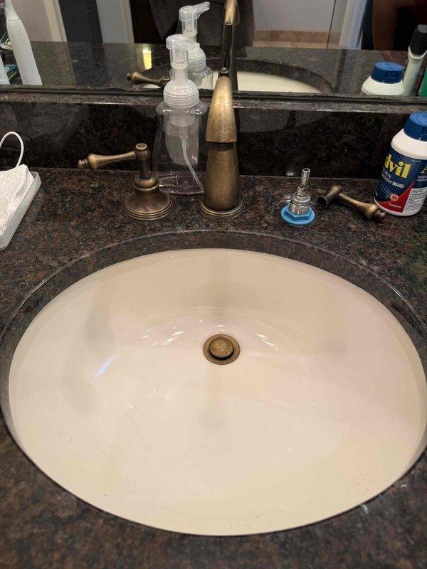 Responded to report of ceiling leak occurring during upstairs shower use. Upon investigation, identified failed faucet cartridge in bathroom sink as source of water intrusion. Removed and inspected valve cartridge, which exhibited significant corrosion and mineral buildup causing improper seal. Replaced defective cartridge and associated rubber gasket to restore proper function and eliminate leak. Responded to report of ceiling leak occurring during upstairs shower use. Upon investigation, identified failed faucet cartridge in bathroom sink as source of water intrusion. Removed and inspected valve cartridge, which exhibited significant corrosion and mineral buildup causing improper seal. Replaced defective cartridge and associated rubber gasket to restore proper function and eliminate leak.