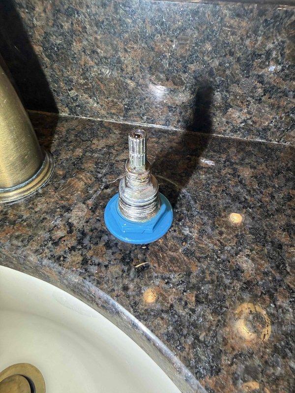 Responded to report of ceiling leak occurring during upstairs shower use. Upon investigation, identified failed faucet cartridge in bathroom sink as source of water intrusion. Removed and inspected valve cartridge, which exhibited significant corrosion and mineral buildup causing improper seal. Replaced defective cartridge and associated rubber gasket to restore proper function and eliminate leak. Responded to report of ceiling leak occurring during upstairs shower use. Upon investigation, identified failed faucet cartridge in bathroom sink as source of water intrusion. Removed and inspected valve cartridge, which exhibited significant corrosion and mineral buildup causing improper seal. Replaced defective cartridge and associated rubber gasket to restore proper function and eliminate leak.