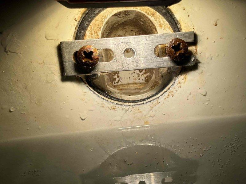 Responded to ceiling leak caused by bathtub overflow above. Upon inspection, identified failed water heater heating element with severely corroded mounting bolts and deteriorated rubber gasket as the source of water intrusion. Removed compromised gasket showing significant rust staining and mineral deposits, then replaced heating element assembly and installed new gasket to restore proper seal and eliminate leak. Responded to ceiling leak caused by bathtub overflow above. Upon inspection, identified failed water heater heating element with severely corroded mounting bolts and deteriorated rubber gasket as the source of water intrusion. Removed compromised gasket showing significant rust staining and mineral deposits, then replaced heating element assembly and installed new gasket to restore proper seal and eliminate leak.