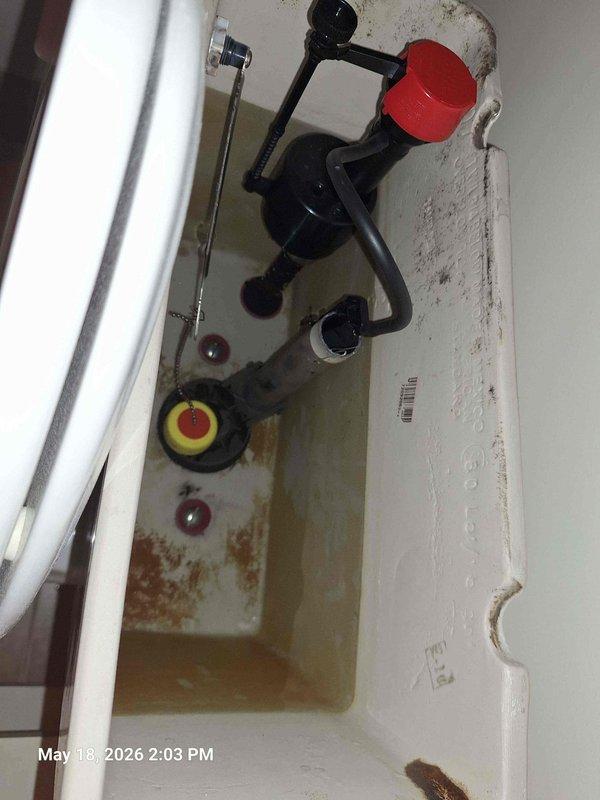Responded to bonus room bathroom for running toilet complaint. Diagnosed faulty fill valve assembly with sticking float mechanism causing continuous water flow. Replaced complete fill valve assembly with new unit and installed braided stainless steel supply line with angle stop valve to ensure proper water supply connection and shutoff capability.