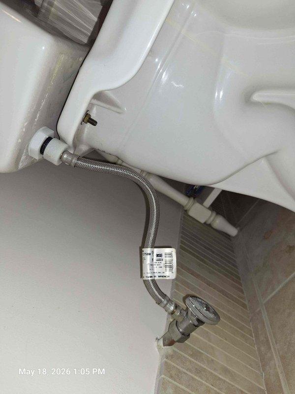 Responded to bonus room bathroom for running toilet complaint. Diagnosed faulty fill valve assembly with sticking float mechanism causing continuous water flow. Replaced complete fill valve assembly with new unit and installed braided stainless steel supply line with angle stop valve to ensure proper water supply connection and shutoff capability.