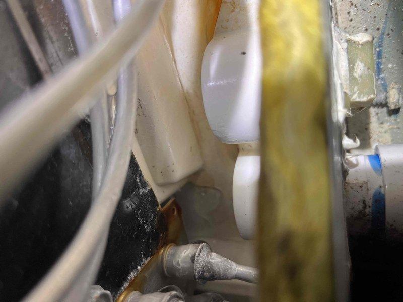 Responded to service call for leaking condensate drain line. Upon inspection, found PVC condensate piping with significant interior staining and buildup causing drainage issues. Documented existing condition showing brownish-yellow discoloration inside pipe fittings and residue accumulation on exterior surfaces. Inspected drain line connections, trap assembly, and termination point. System components showed signs of age and required maintenance to restore proper condensate flow and prevent future water damage.