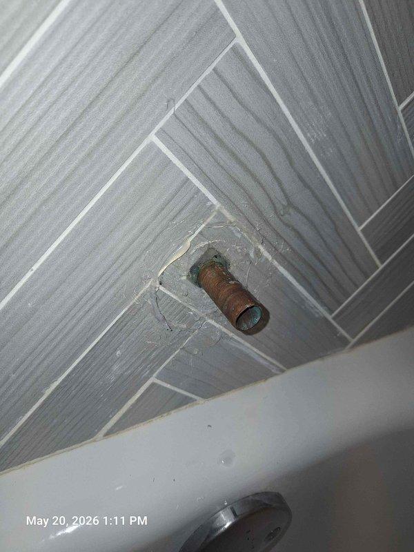 Replaced corroded tub spout on existing copper stub-out pipe. Removed old fixture showing significant mineral buildup and oxidation, cleaned pipe threads, and installed new chrome tub spout with proper seal to ensure leak-free operation.