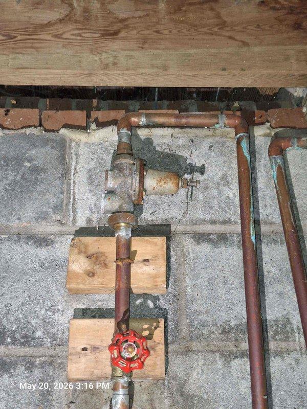 Conducted comprehensive plumbing estimate inspection for prospective home purchase, evaluating aging plumbing infrastructure including corroded copper piping with significant oxidation and patina buildup on supply lines. Assessed water heater installation and provided recommendations for expansion tank installation and bleeder valve addition to improve system safety and longevity. Investigated drainage concerns affecting multiple fixtures including sinks and bathtub, examining waste line configuration and venting. Documented existing conditions of basement plumbing system, noting aged gate valve assembly, pipe support mounting, and overall infrastructure condition for estimate preparation.