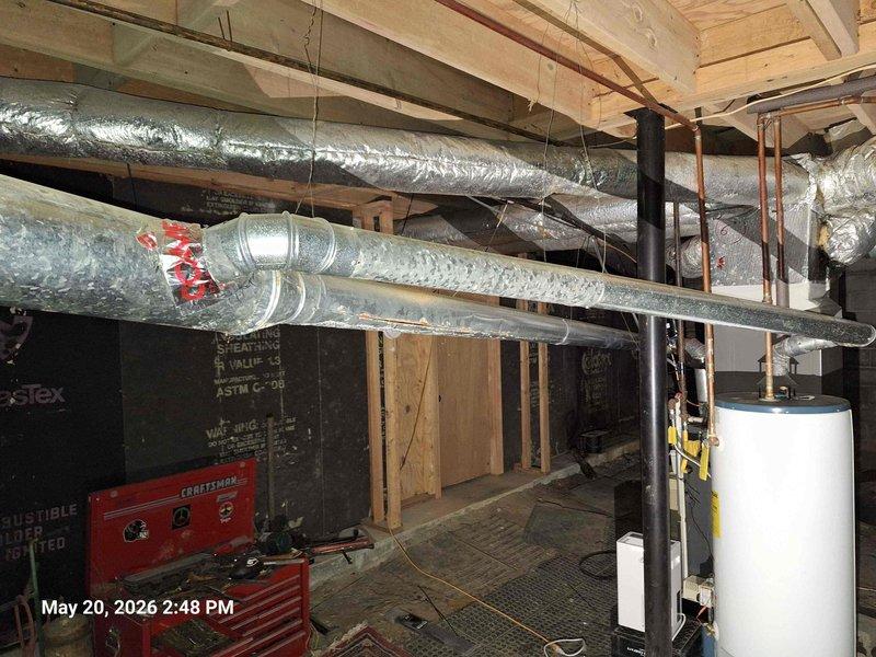 Conducted comprehensive plumbing estimate inspection for prospective home purchase, evaluating aging plumbing infrastructure including corroded copper piping with significant oxidation and patina buildup on supply lines. Assessed water heater installation and provided recommendations for expansion tank installation and bleeder valve addition to improve system safety and longevity. Investigated drainage concerns affecting multiple fixtures including sinks and bathtub, examining waste line configuration and venting. Documented existing conditions of basement plumbing system, noting aged gate valve assembly, pipe support mounting, and overall infrastructure condition for estimate preparation.