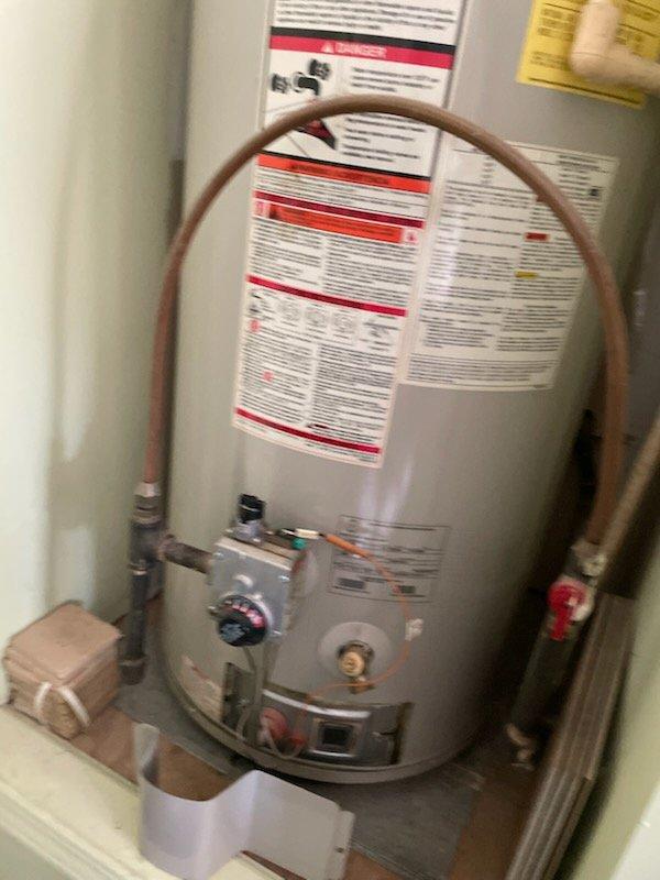 Removed and replaced 18-year-old 40-gallon gas water heater with new A.O. Smith ProMax unit. Installation included proper connection of copper supply lines, gas line hookup, pressure relief valve installation, and mounting of expansion tank. Configured all shut-off valves, verified proper venting, and installed drain pan at base for leak protection. Unit leveled and secured, all connections tested for leaks and proper operation.