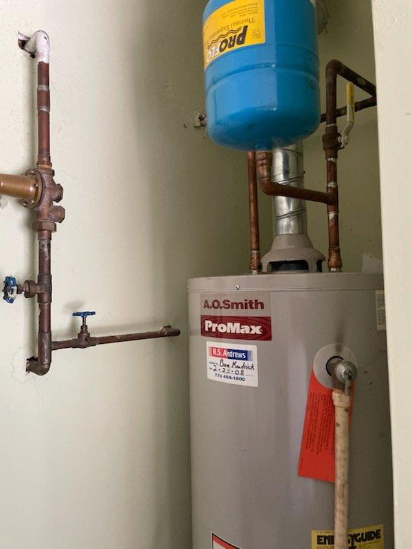 Removed and replaced 18-year-old 40-gallon gas water heater with new A.O. Smith ProMax unit. Installation included proper connection of copper supply lines, gas line hookup, pressure relief valve installation, and mounting of expansion tank. Configured all shut-off valves, verified proper venting, and installed drain pan at base for leak protection. Unit leveled and secured, all connections tested for leaks and proper operation.