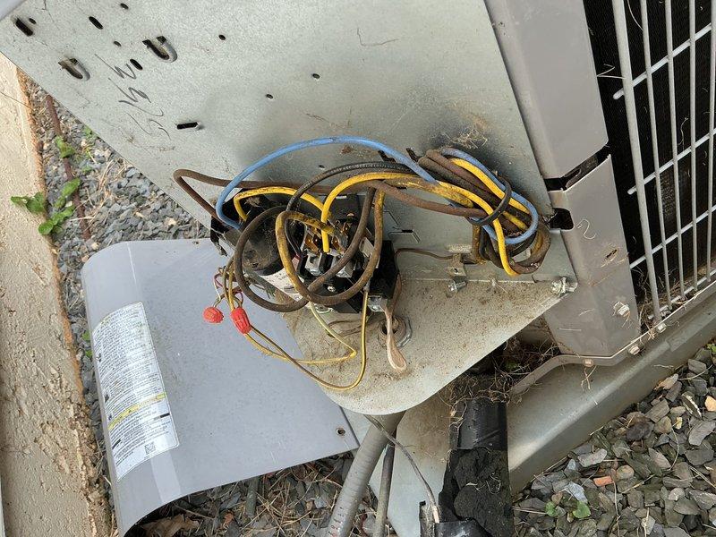 Completed comprehensive maintenance inspection on two HVAC systems for property with no prior service history since occupancy. Outdoor condensing unit inspection revealed disorganized low-voltage wiring on top of equipment requiring attention, with unit positioned on concrete pad showing typical outdoor weathering. Indoor air handler examination identified significant rust-colored condensate accumulation in drain pan beneath evaporator coil assembly, indicating potential drainage issue or biological growth requiring monitoring. Heat exchanger coils and serpentine tubing inspected and found intact with normal operational wear. All accessible components evaluated for proper function and age-related deterioration.